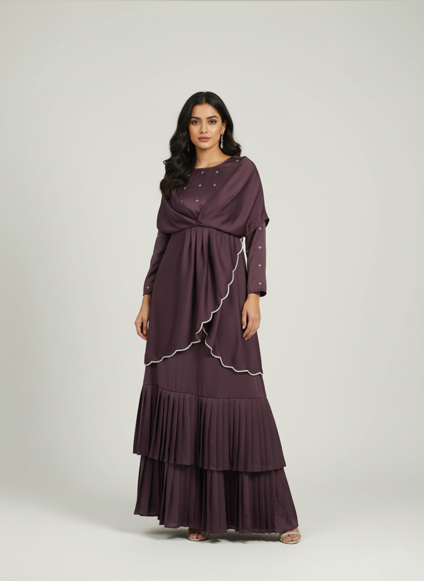 Woman wearing a long, dark purple dress with a white trim on a light gray background