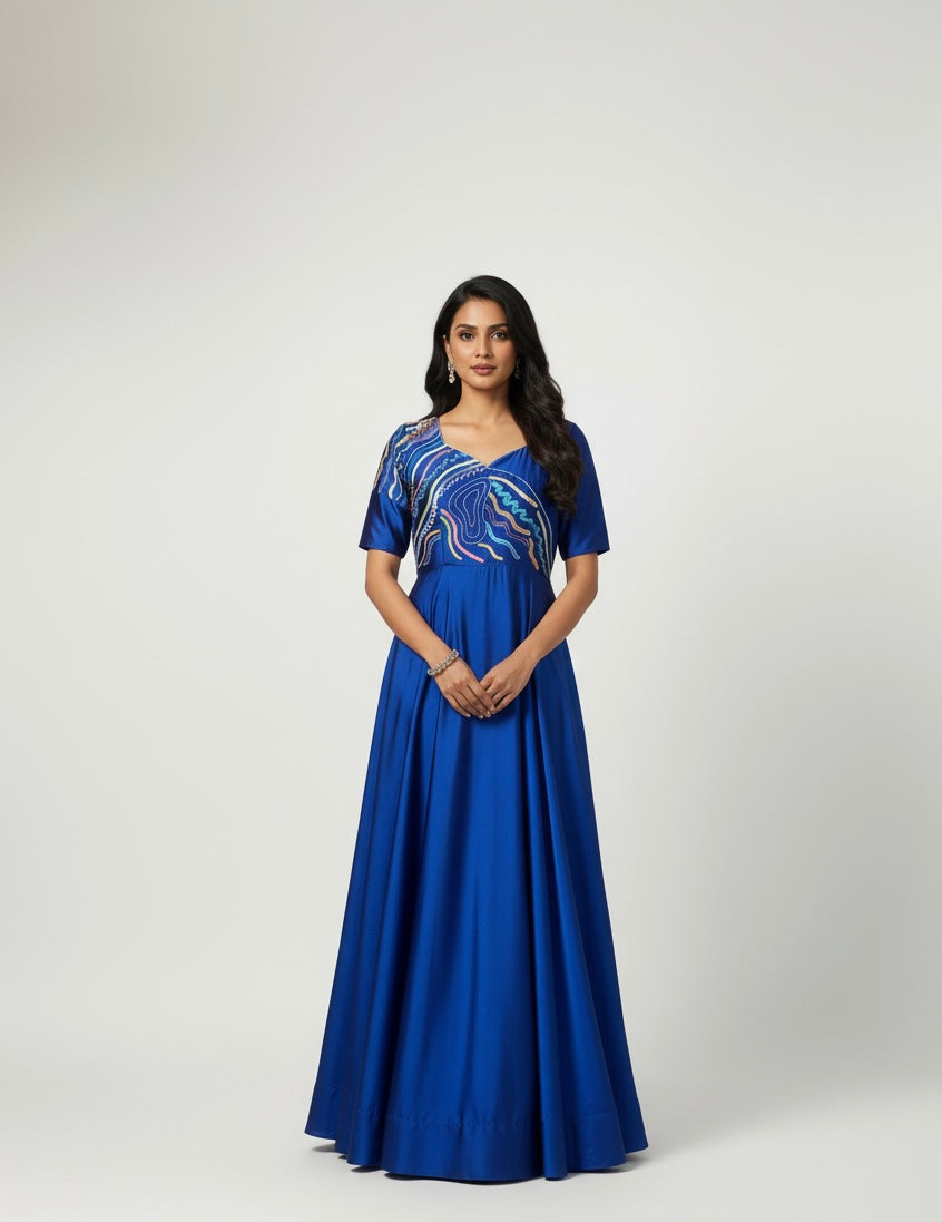 Woman wearing a blue dress with a pattern on a white background