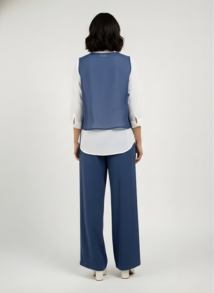 Woman wearing a blue vest over a white shirt with matching pants on a white background