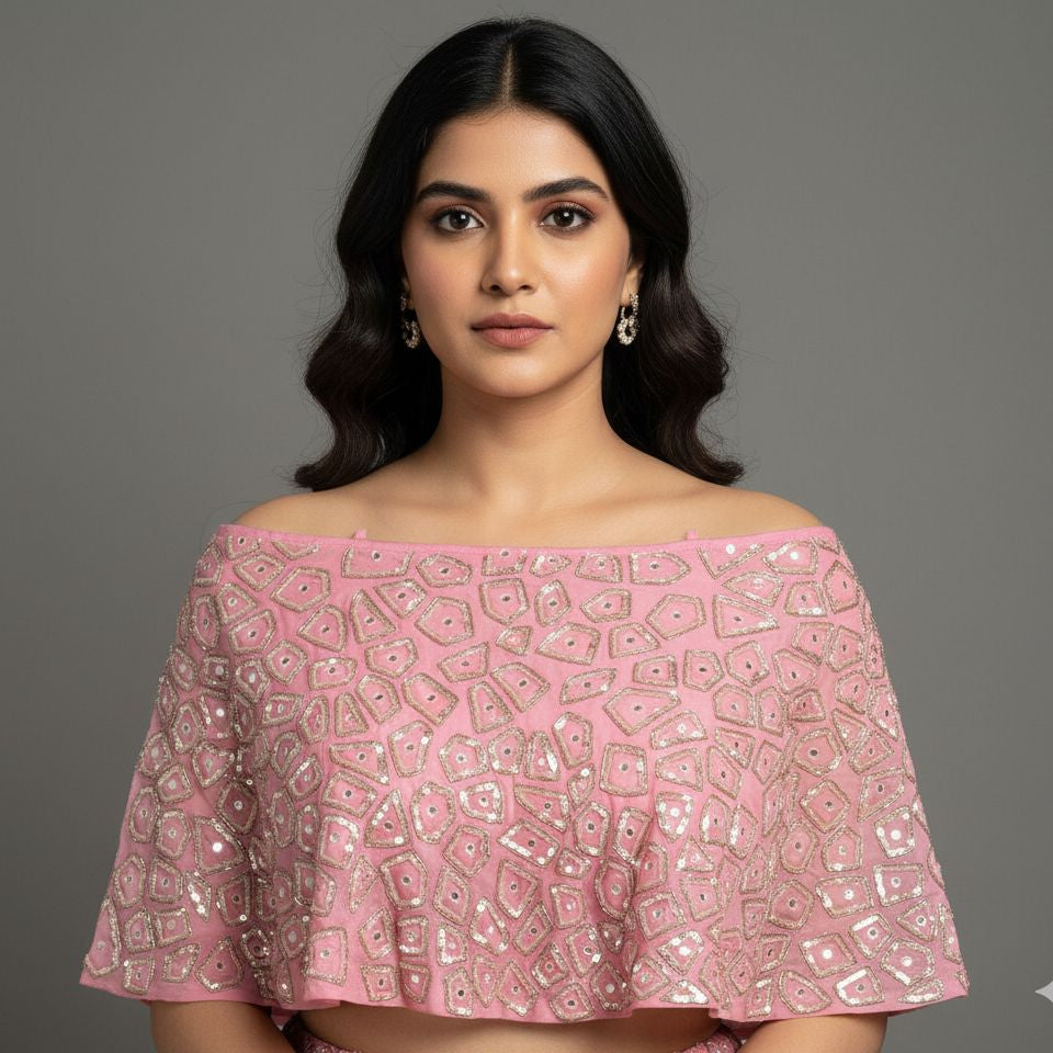 Woman wearing a pink off-shoulder top with geometric patterns on a gray background