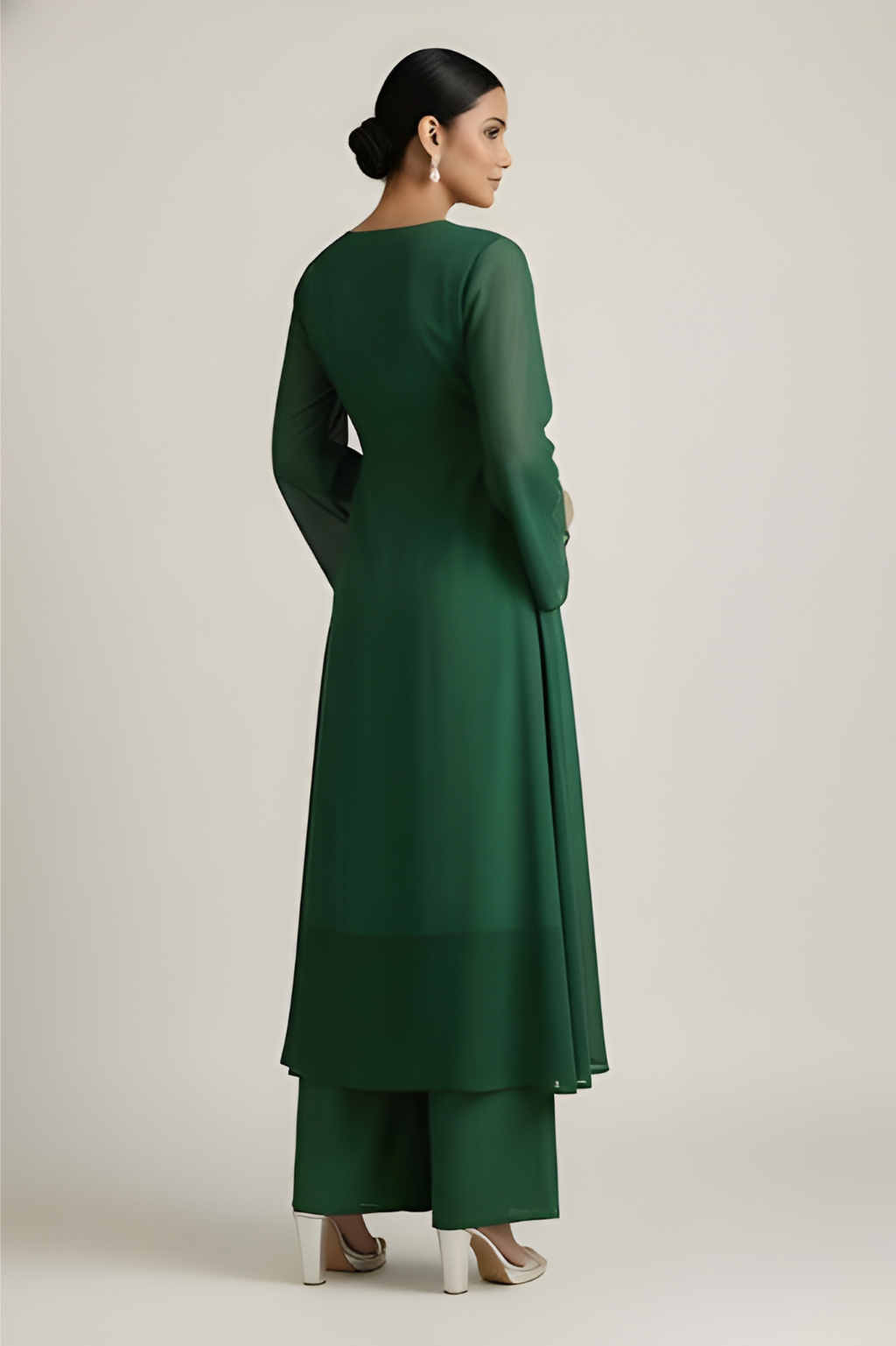 Woman wearing a green dress against a plain background