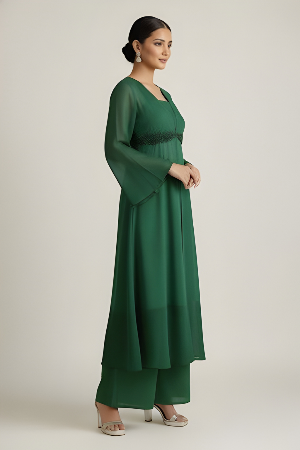Woman wearing a green dress with a plain background