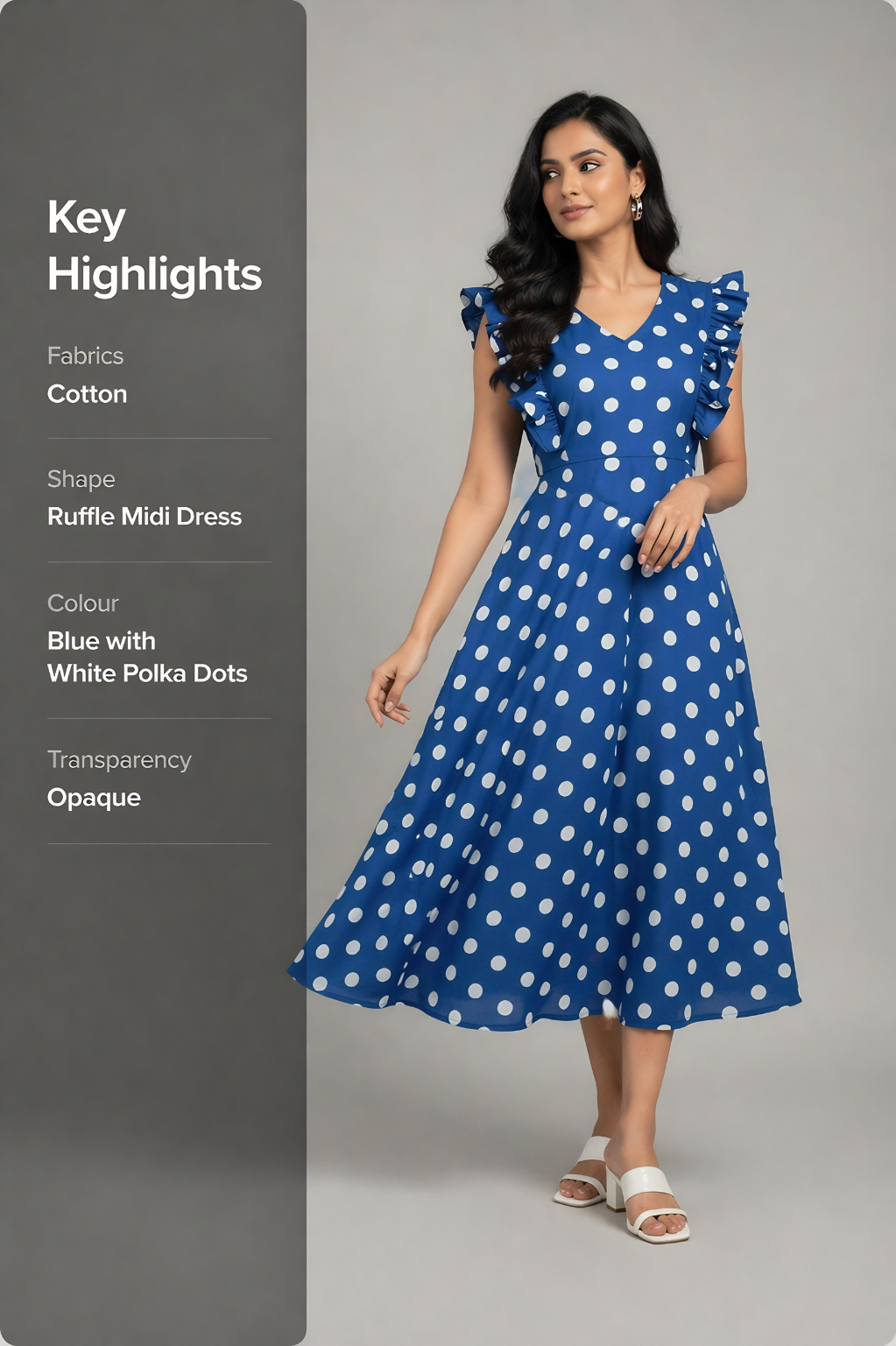 Woman wearing a blue dress with white polka dots on a gray background