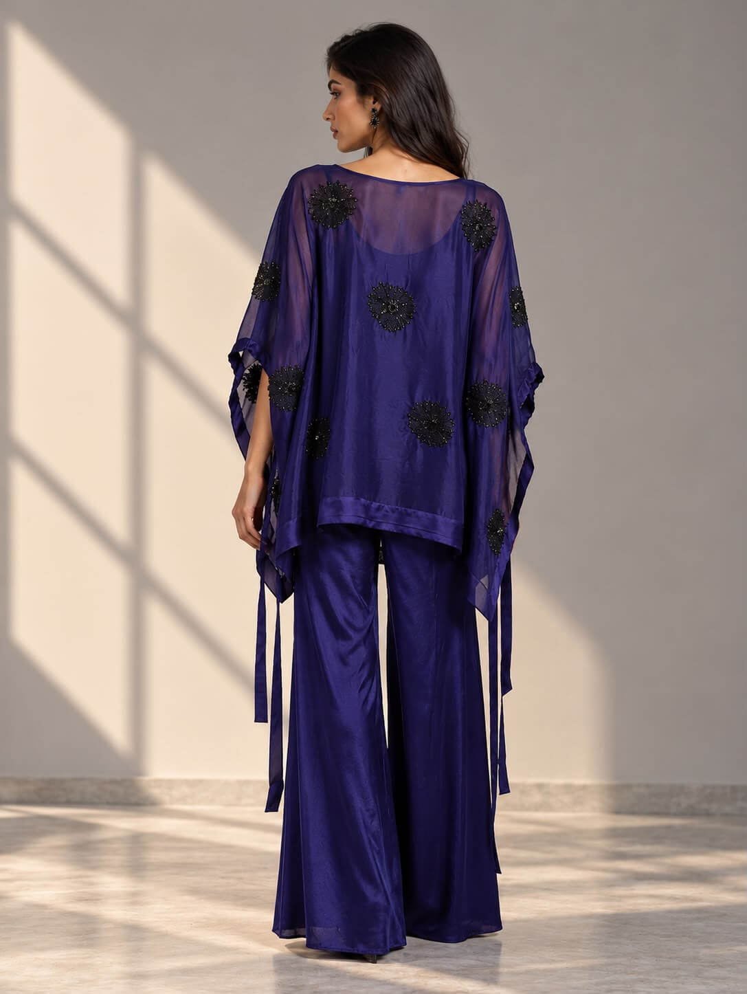 Full-length navy organza co-ord outfit featuring a flowy overlay top, black tubelight work and matching wide-leg pants.