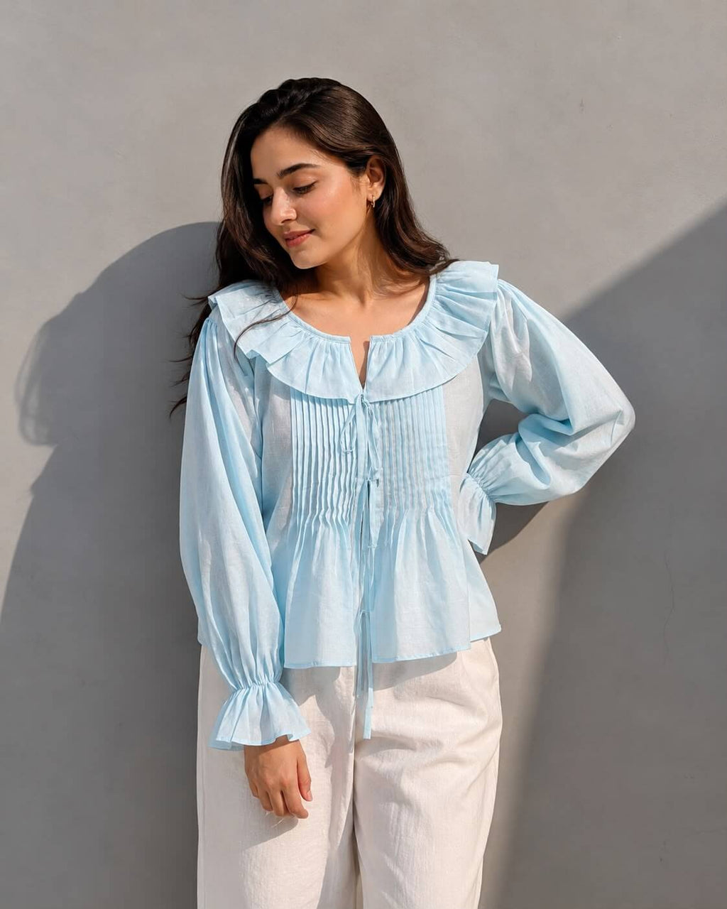 Women's sky blue cotton blouse featuring pintuck detailing and full sleeves.