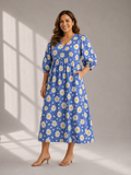 Woman wearing blue cotton midi dress with white daisy floral print front view