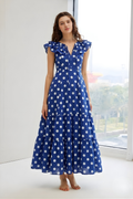 Woman wearing blue polka dot ruffle sleeve midi dress full length