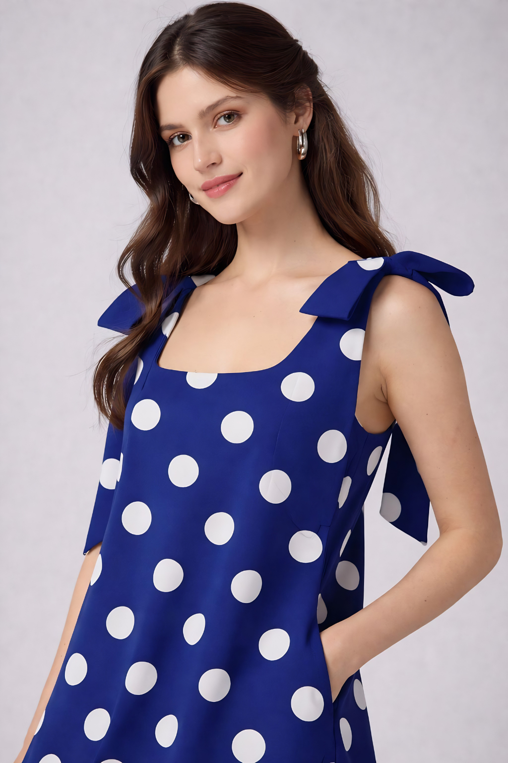 Blue mini dress with white polka dots side pose
