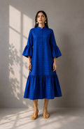 Woman wearing a cobalt blue striped cotton midi dress with bell sleeves and a mandarin collar.