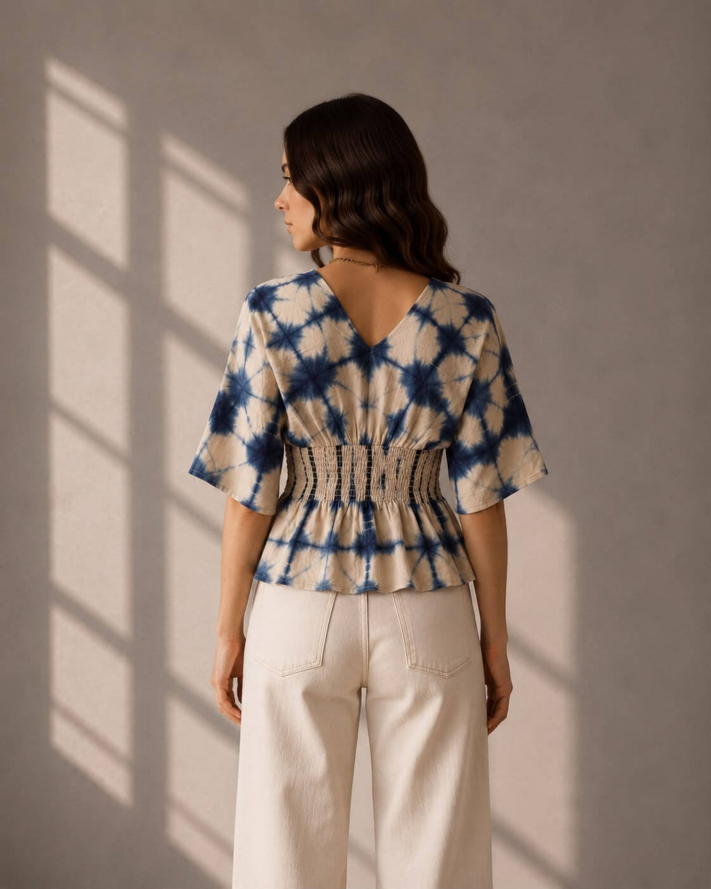 Blue and white cotton top featuring kimono sleeves and a V-neckline.
