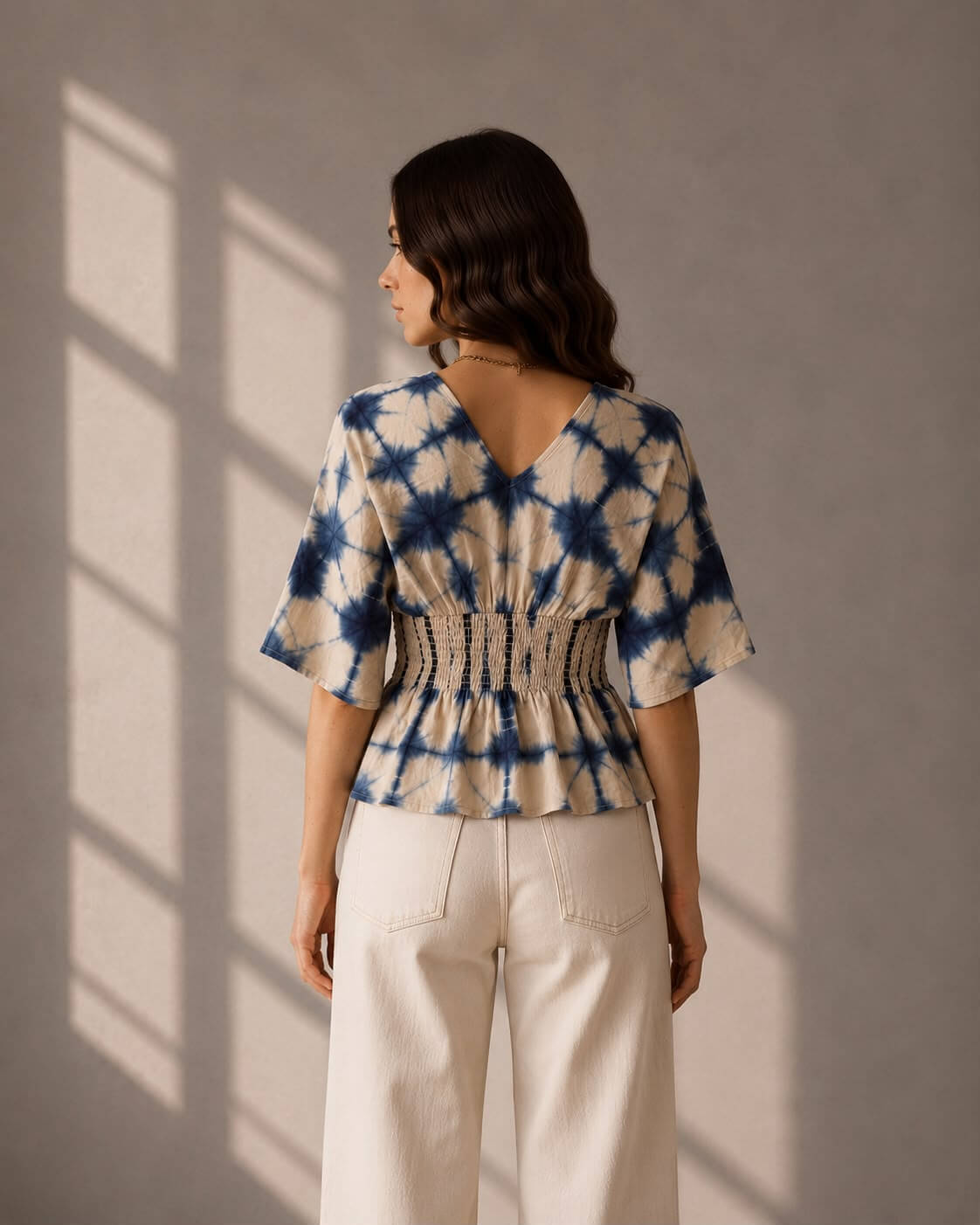 Blue and white cotton top featuring kimono sleeves and a V-neckline.