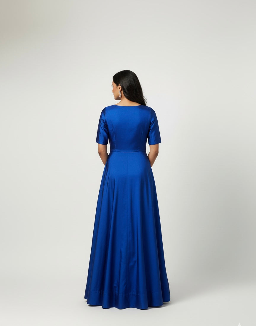 Woman wearing a blue dress against a white background