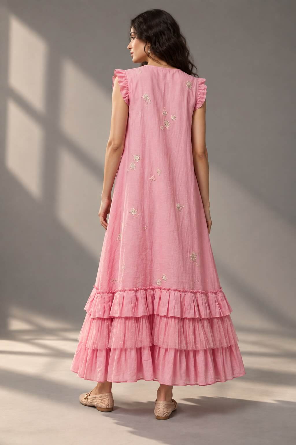 Full-length view of blush pink ruffle tiered midi dress by Gehru Label