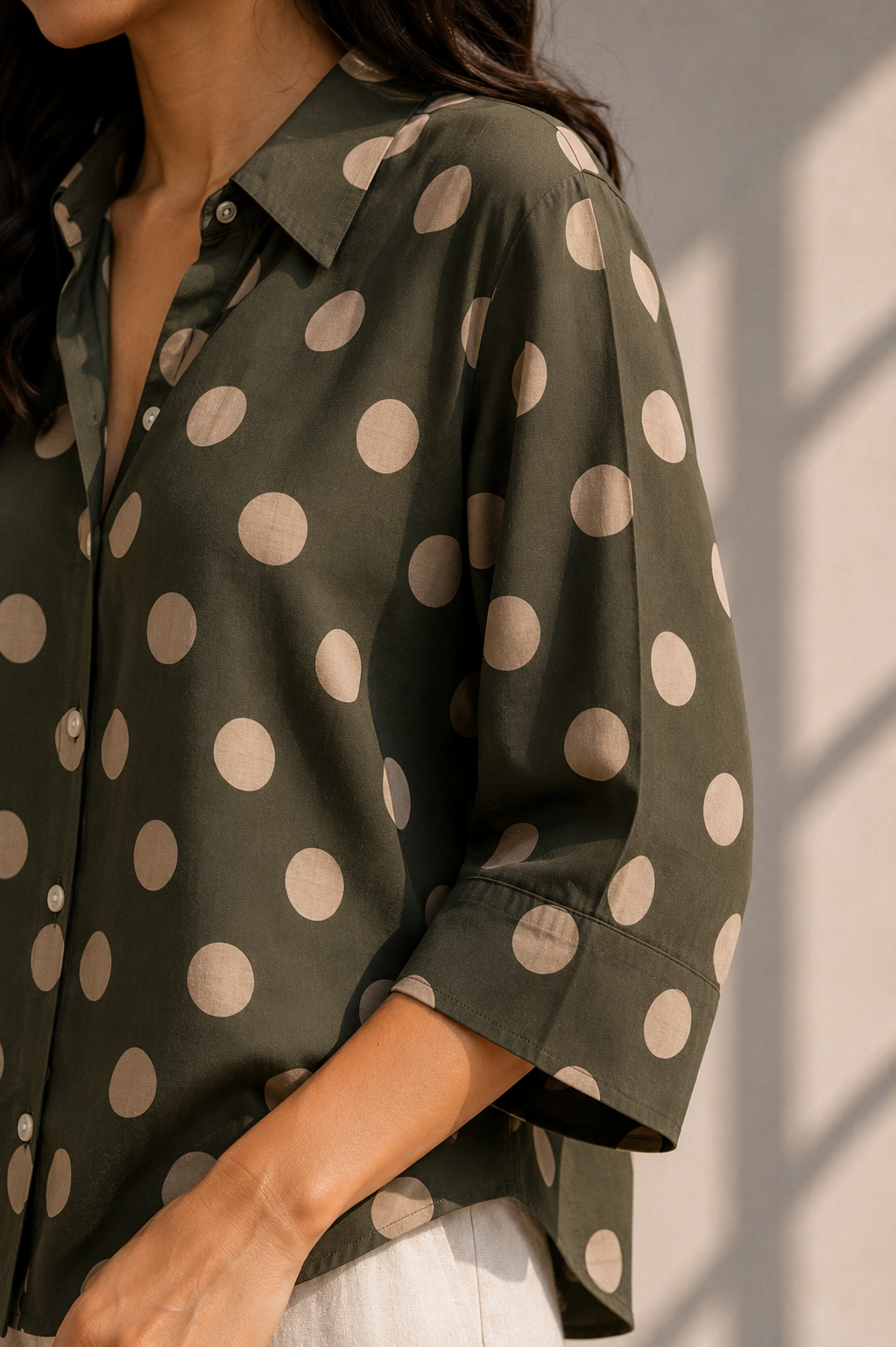 Close-up sleeve detail of bottle green polka dot cotton shirt with collar