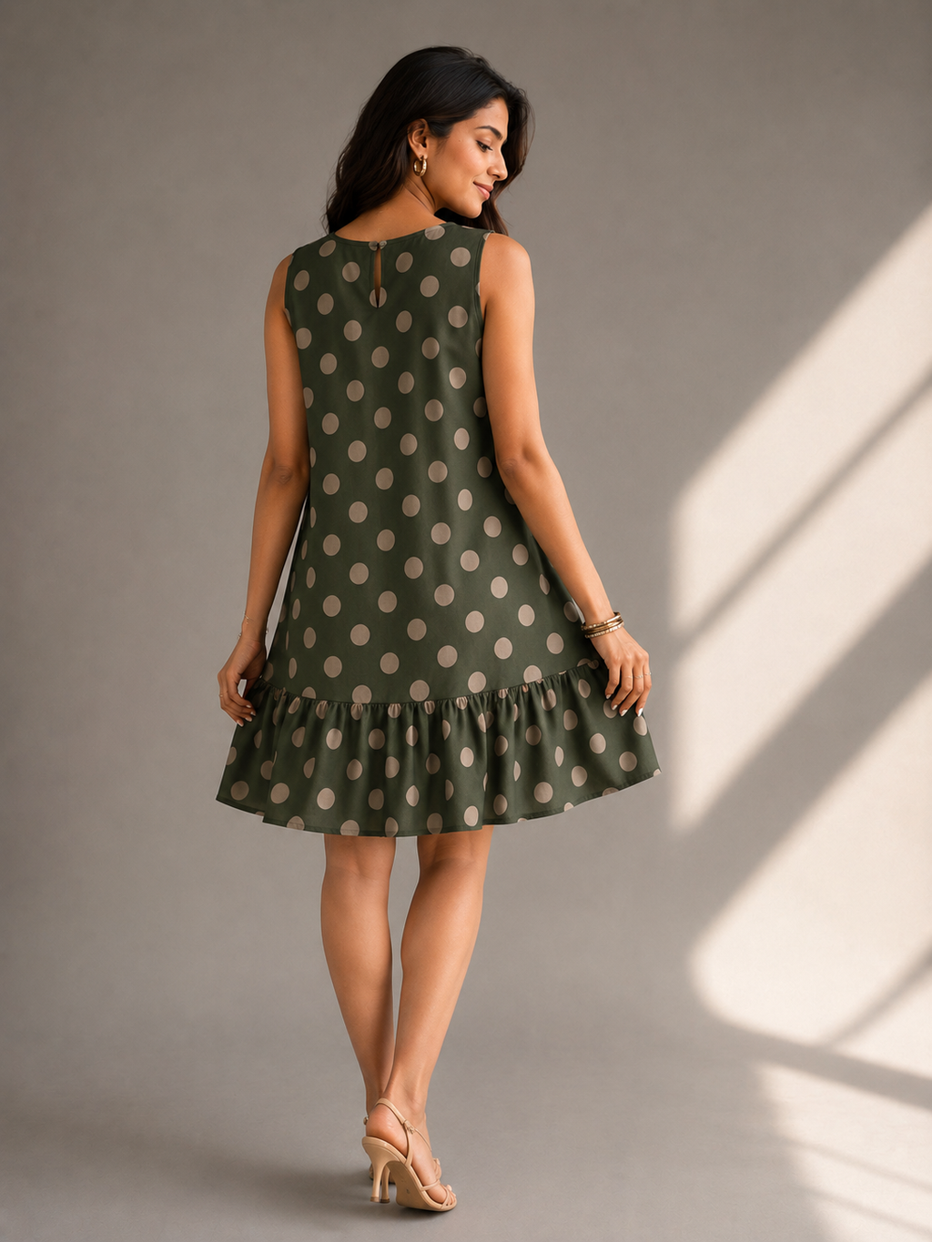 Back view of bottle green polka dot cotton casual dress with ruffle hem