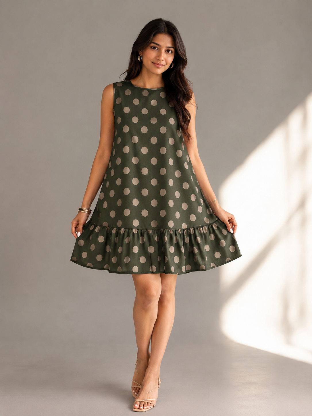 Front view of bottle green polka dot cotton sleeveless ruffle dress for women