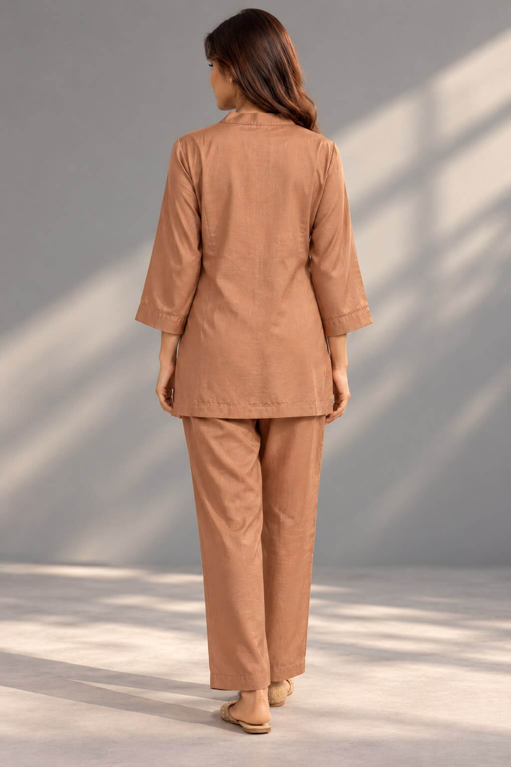 Brown co-ord outfit featuring decorative hem motif and straight-fit trousers