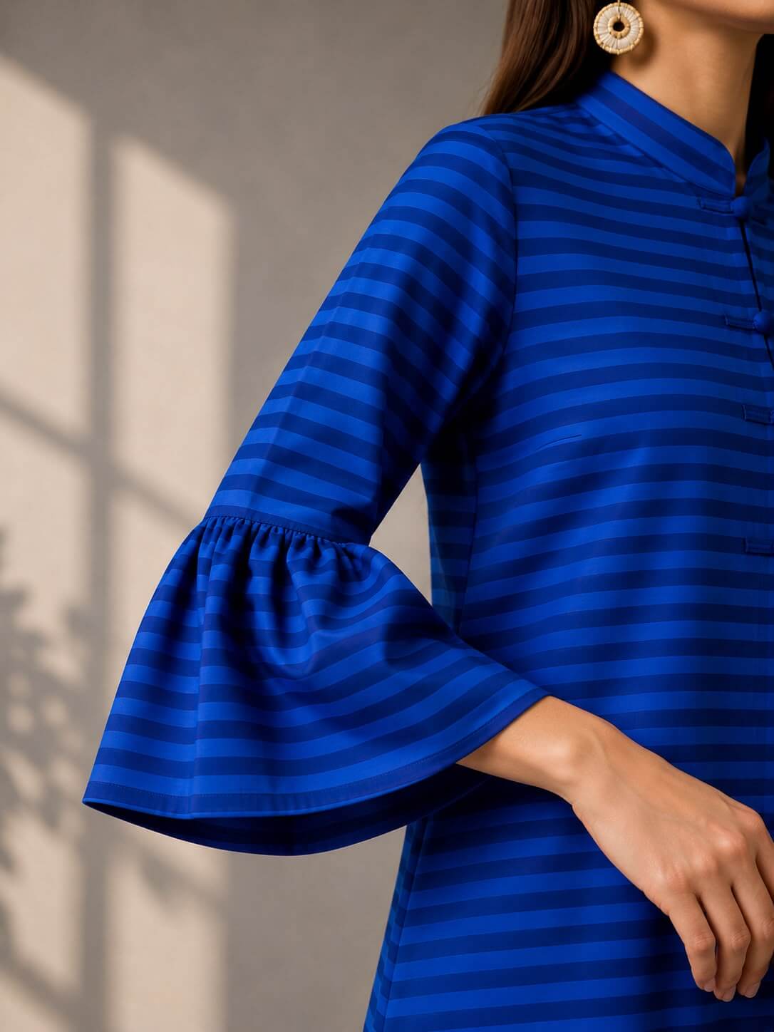 Elegant striped midi dress with statement bell sleeves and concealed front button detailing.