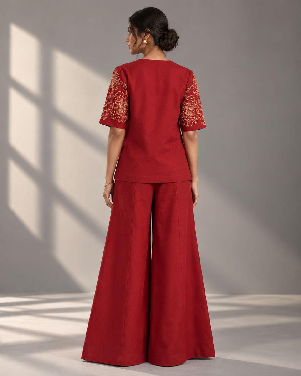 Full-length view of crimson embroidered top and wide-leg trouser co-ord set