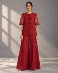 Woman wearing a crimson crape silk co-ord set with Zardosi embroidered sleeves