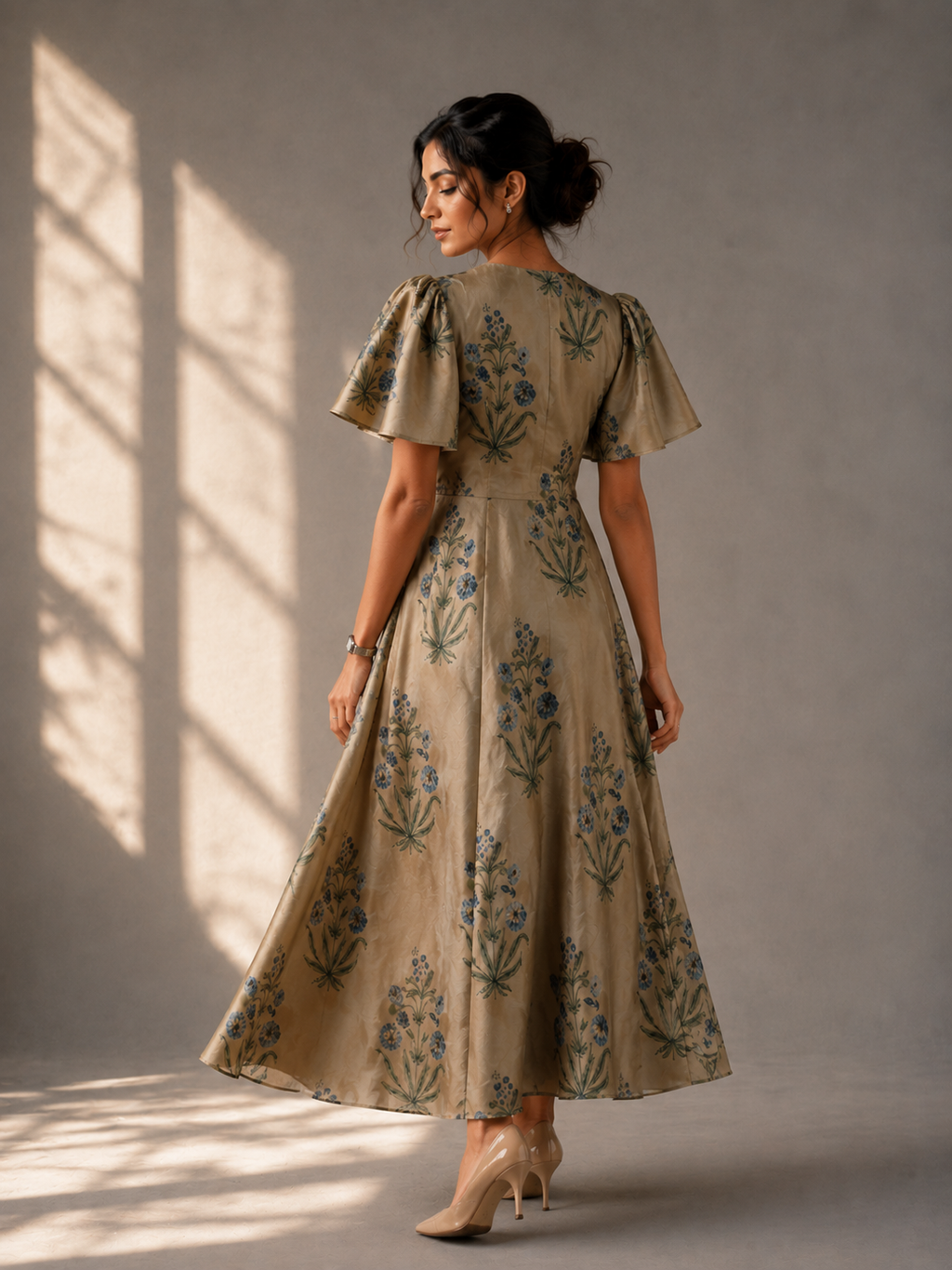 Close-up of flutter sleeves and block print detailing on golden modal silk dress