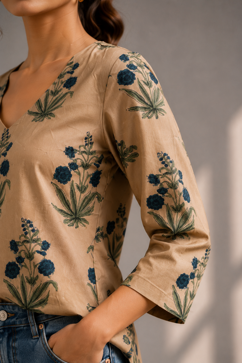 Close-up sleeve detail of golden floral printed modal silk top