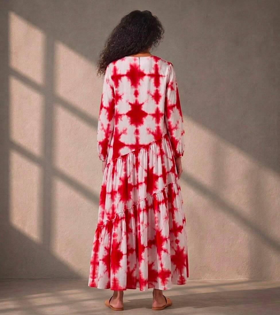 Relaxed fit cotton maxi dress featuring handcrafted red tie-dye and a flowing tiered silhouette.