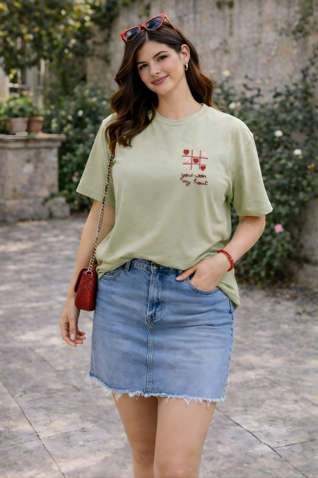 Playful embroidered women’s T-shirt with tic tac toe hearts and romantic quote.