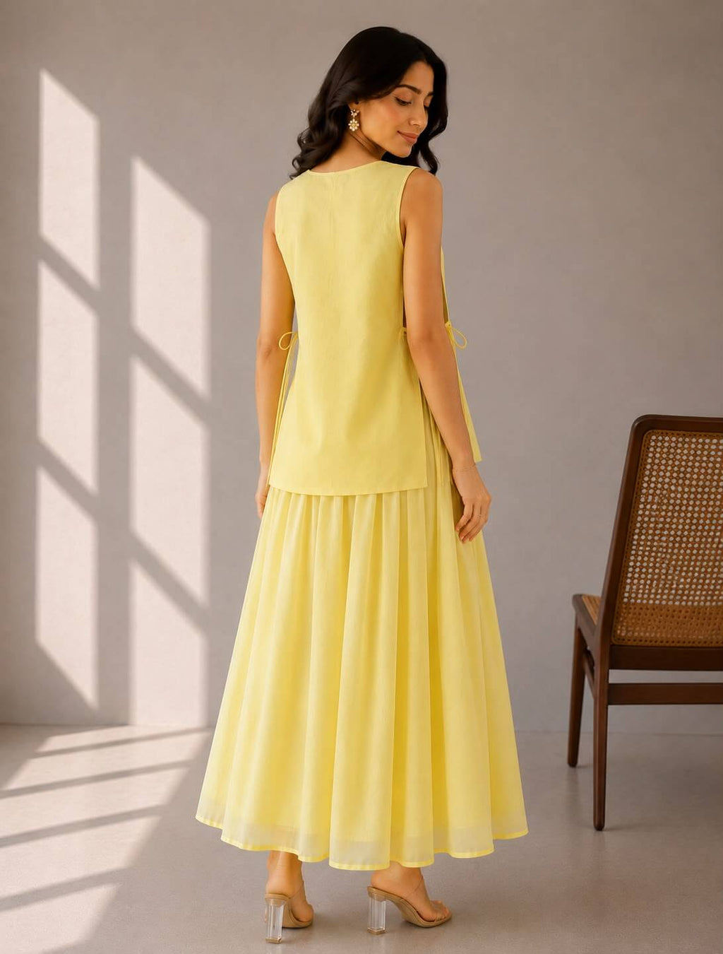Elegant summer cotton dress in butter yellow styled with a detachable artistic vest for a modern festive look.