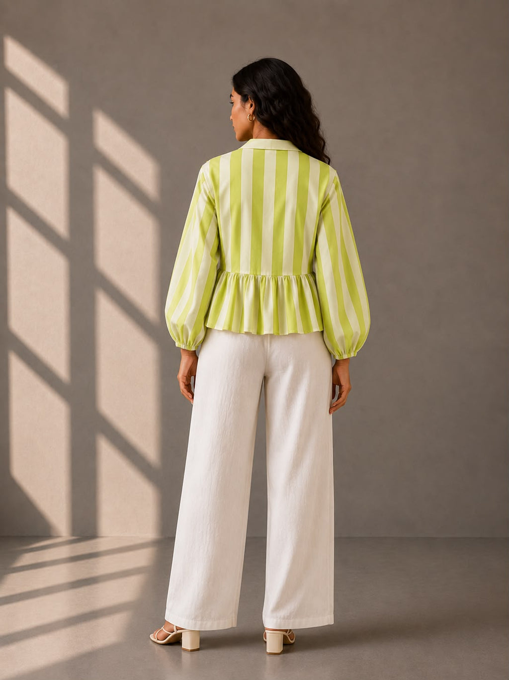 Relaxed fit striped blouse styled with white wide-leg trousers.