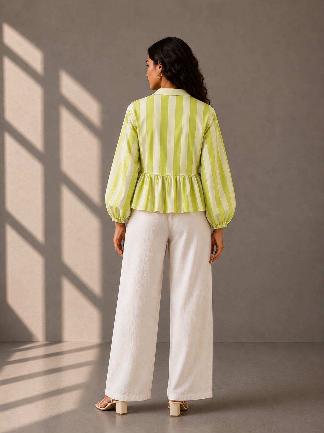 Relaxed fit striped blouse styled with white wide-leg trousers.