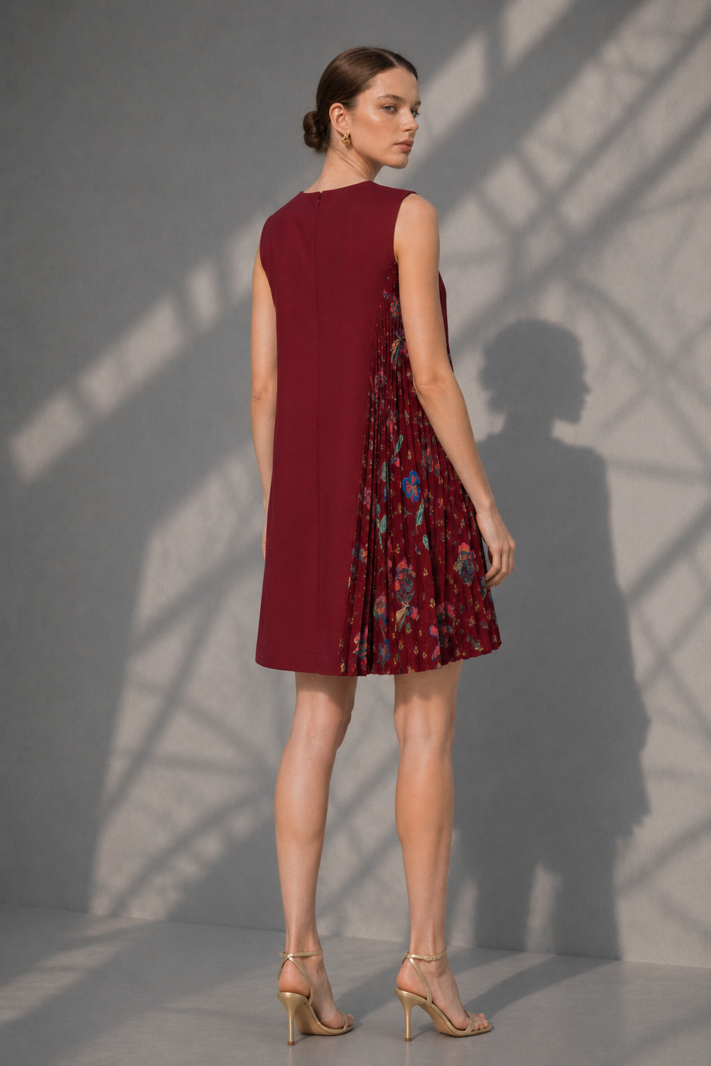 Back view of elegant maroon floral pleated panel dress