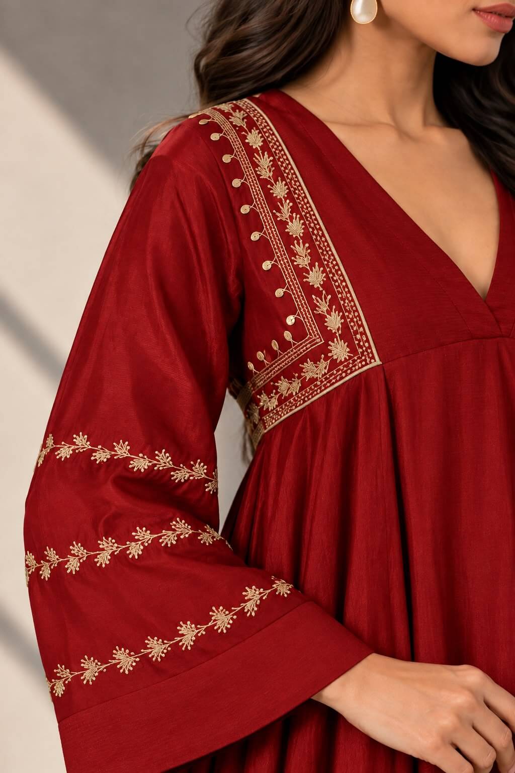 Maroon Anarkali gown with V-neckline and embroidered flared sleeves