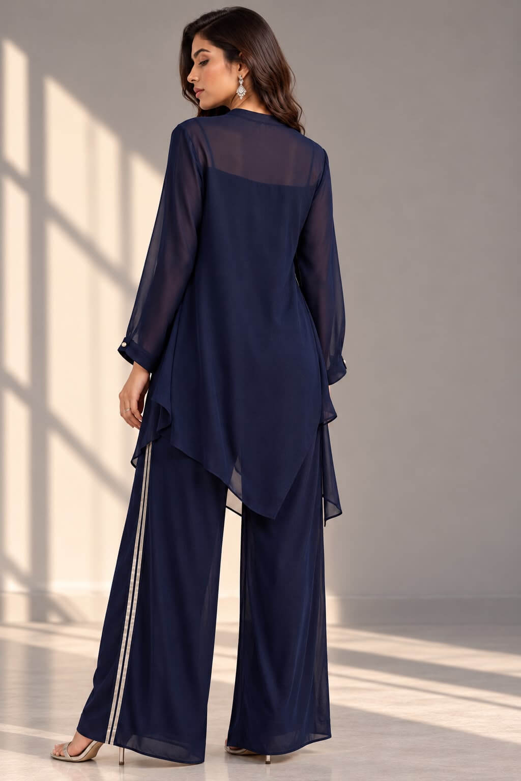 Full-length view of a navy blue georgette co-ord set with silver gotta lace detailing, an asymmetrical draped top and wide-leg trousers.