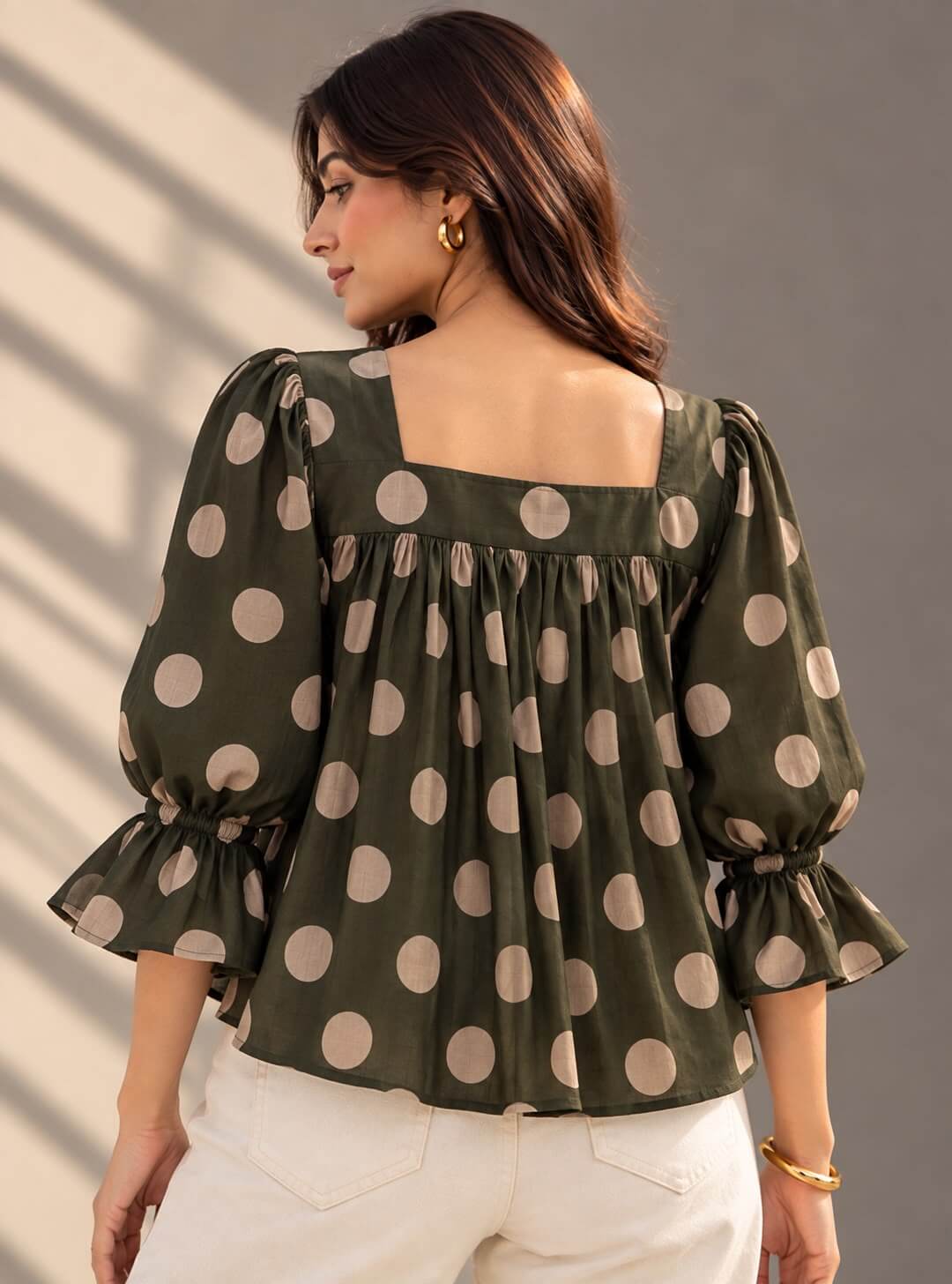 Back view of olive green polka dot cotton top
