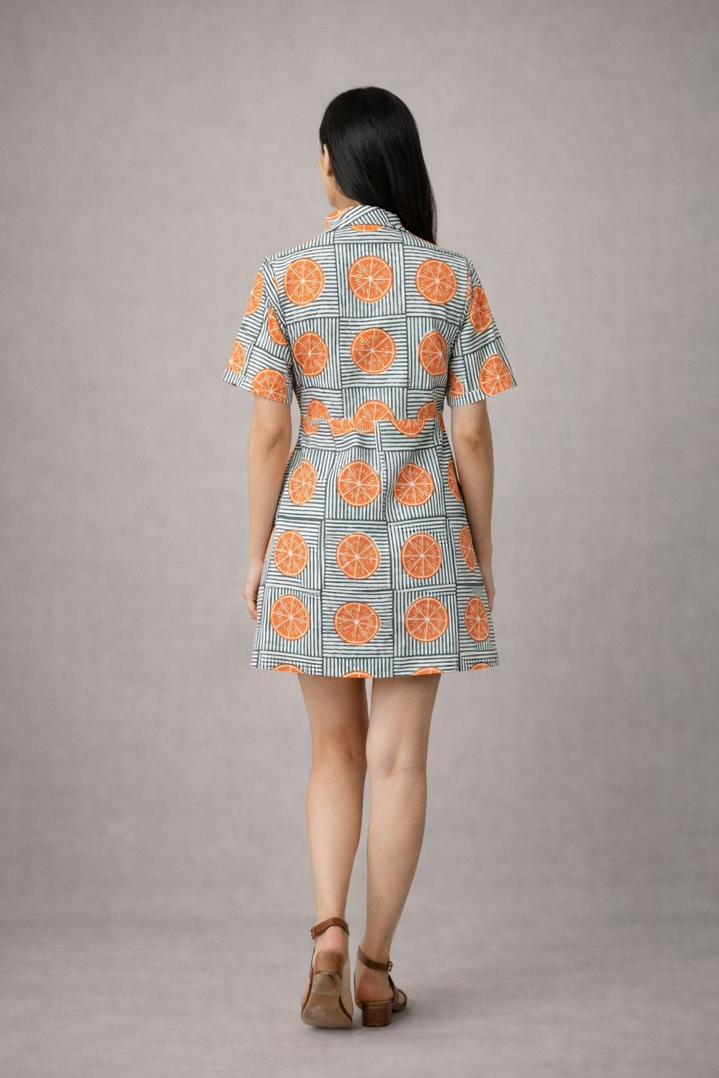 Women’s orange printed day dress styled for summer vacation look