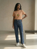 Peach women’s T-shirt featuring colorful tulip embellishment on the front