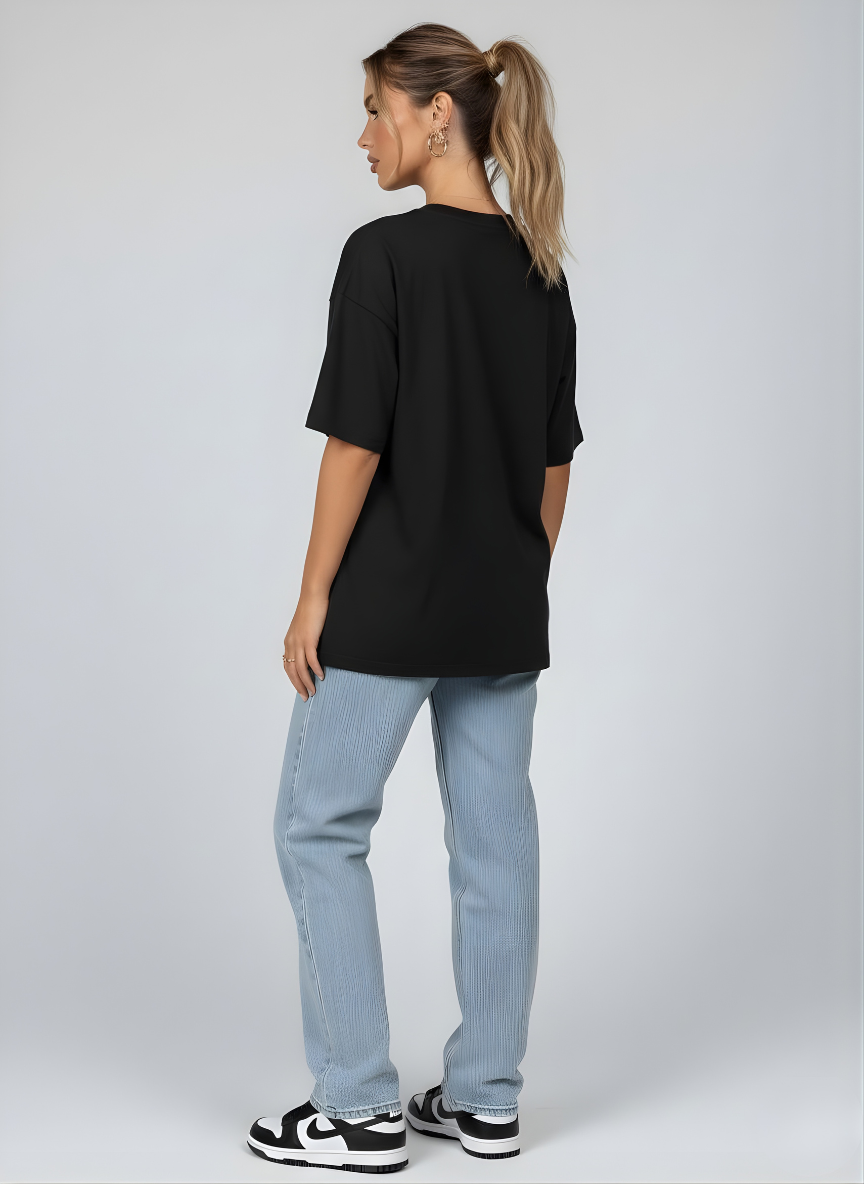 Casual oversized black t-shirt styled with denim