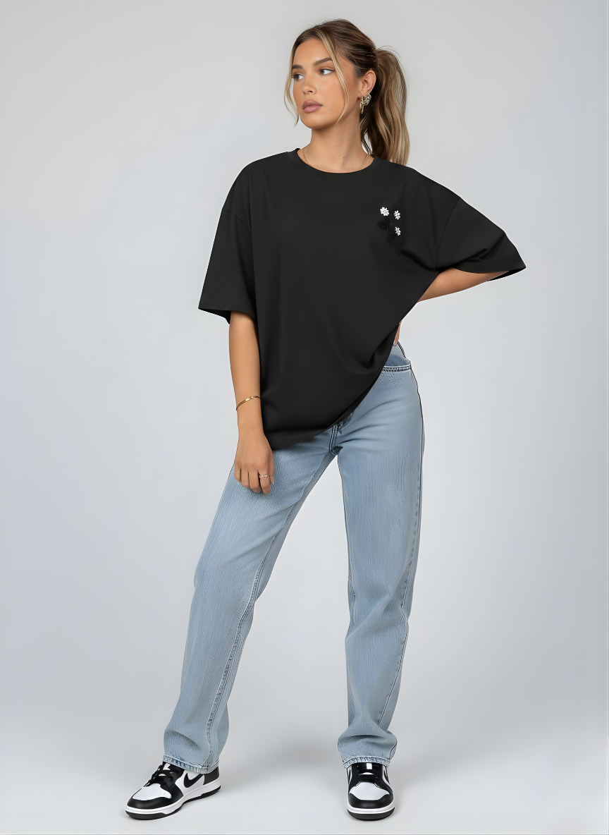 Relaxed fit black tee with delicate pearl flower detail