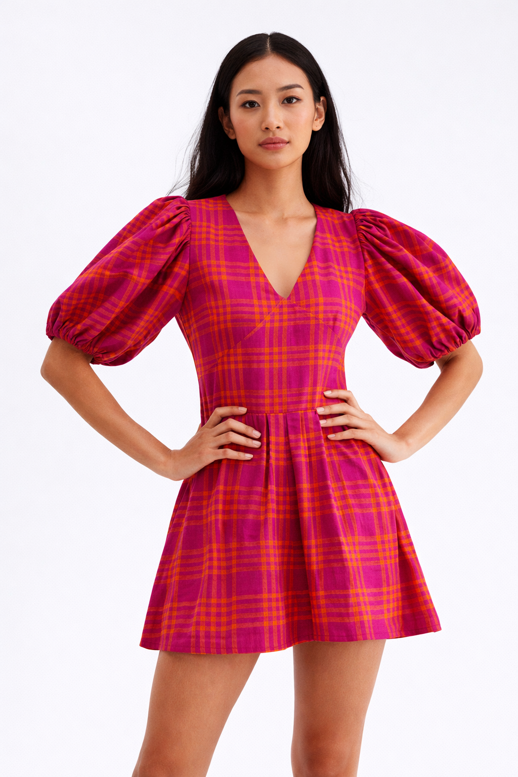 Model wearing pink check puff sleeve mini dress with structured waist