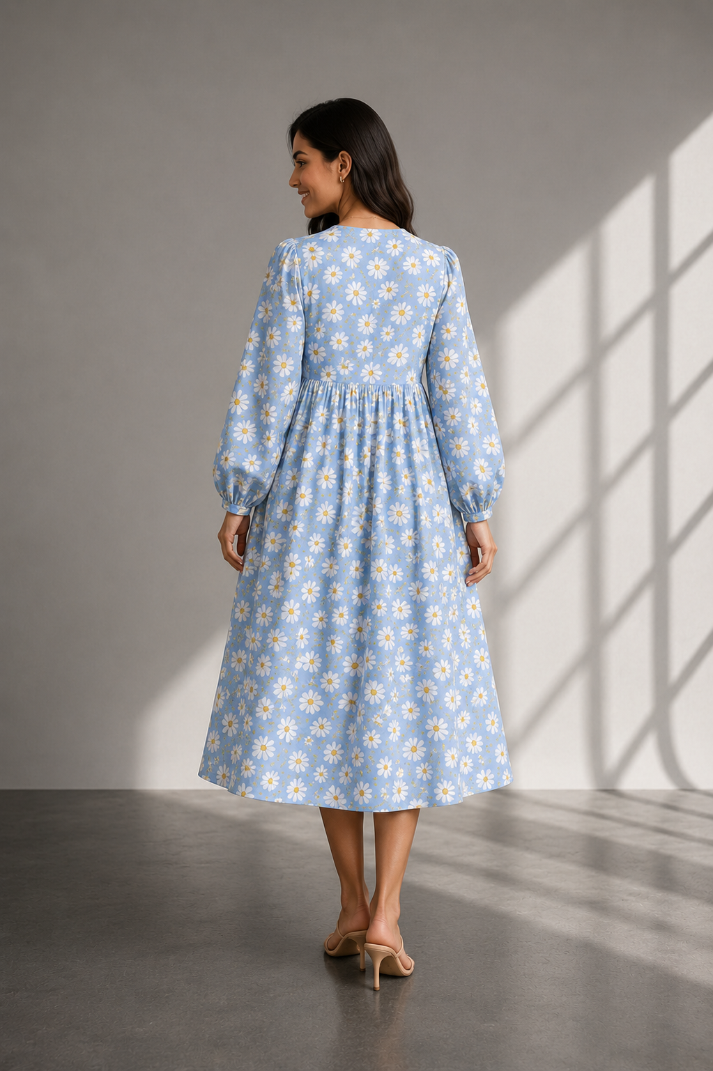 Close-up of powder blue cotton fabric featuring white daisy floral print.