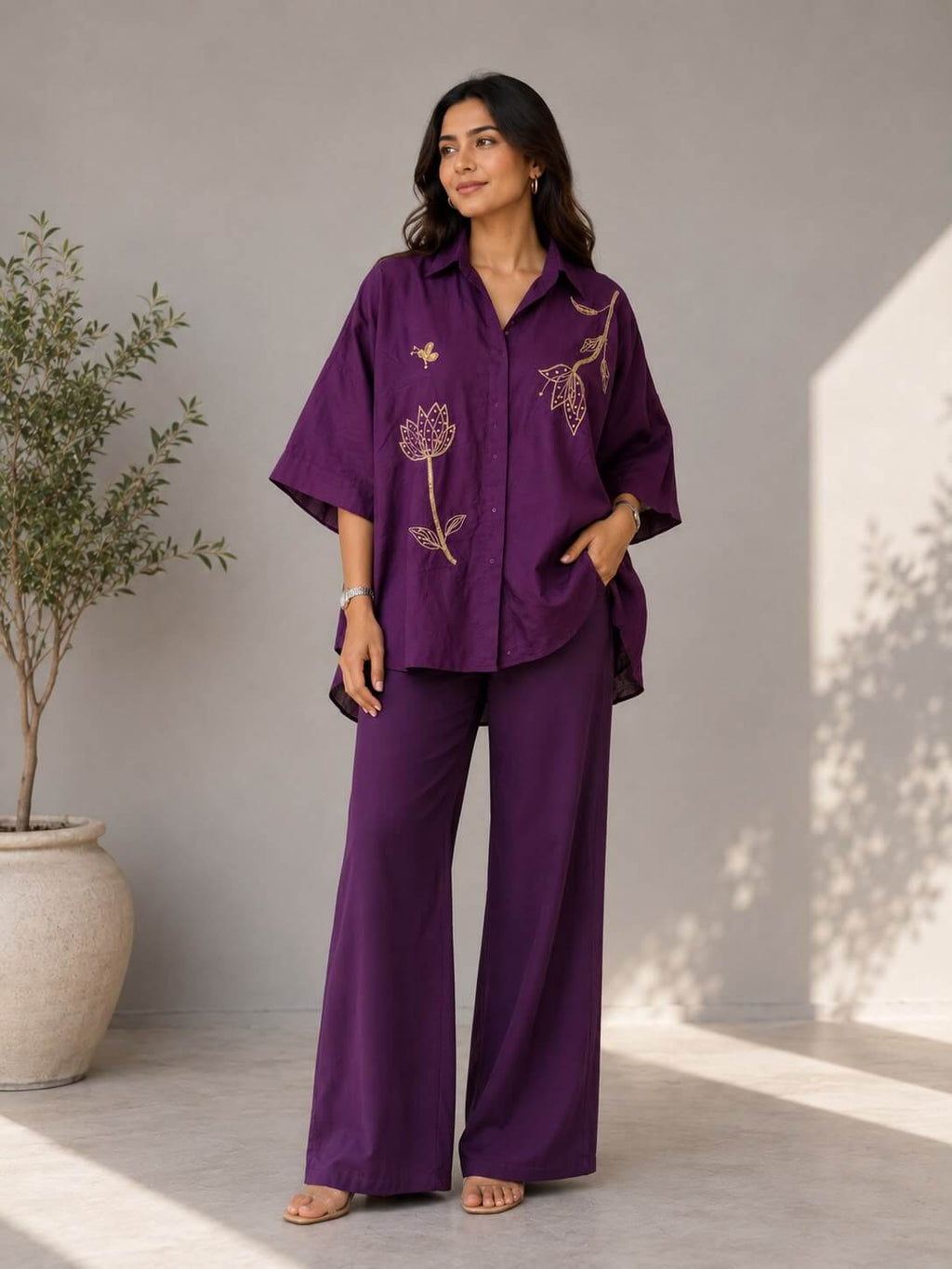 Women's purple cotton co-ord set with floral embroidery and matching wide-leg pants.