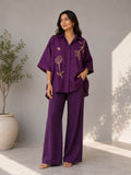 Women's purple cotton co-ord set with floral embroidery and matching wide-leg pants.