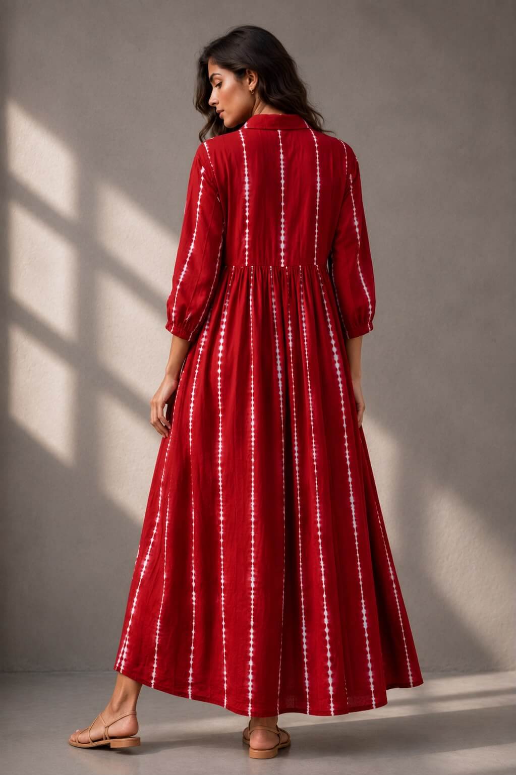 Elegant cotton maxi dress featuring a collared neckline and gathered waist.