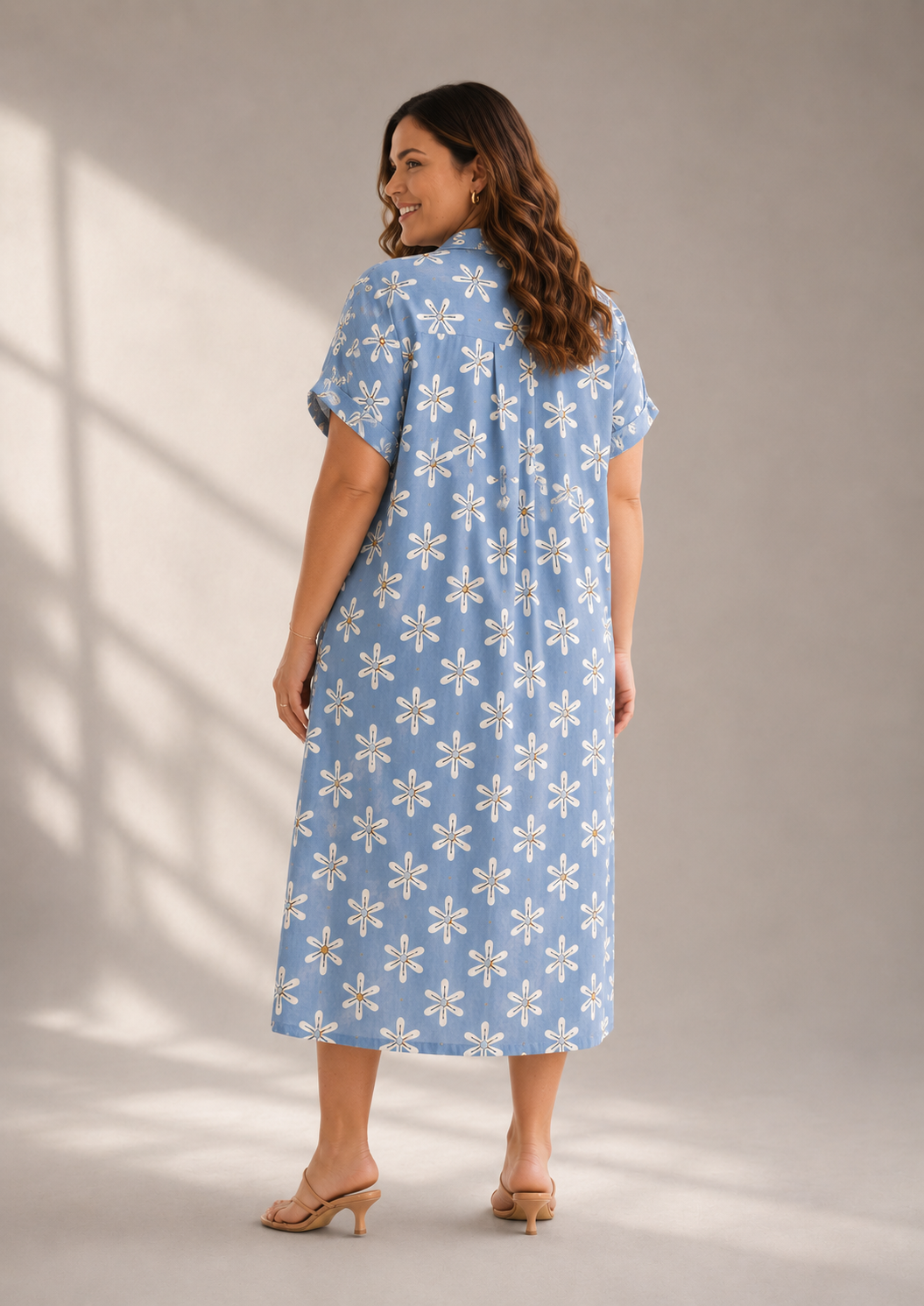 Back view of breathable cotton floral shirt dress with midi length