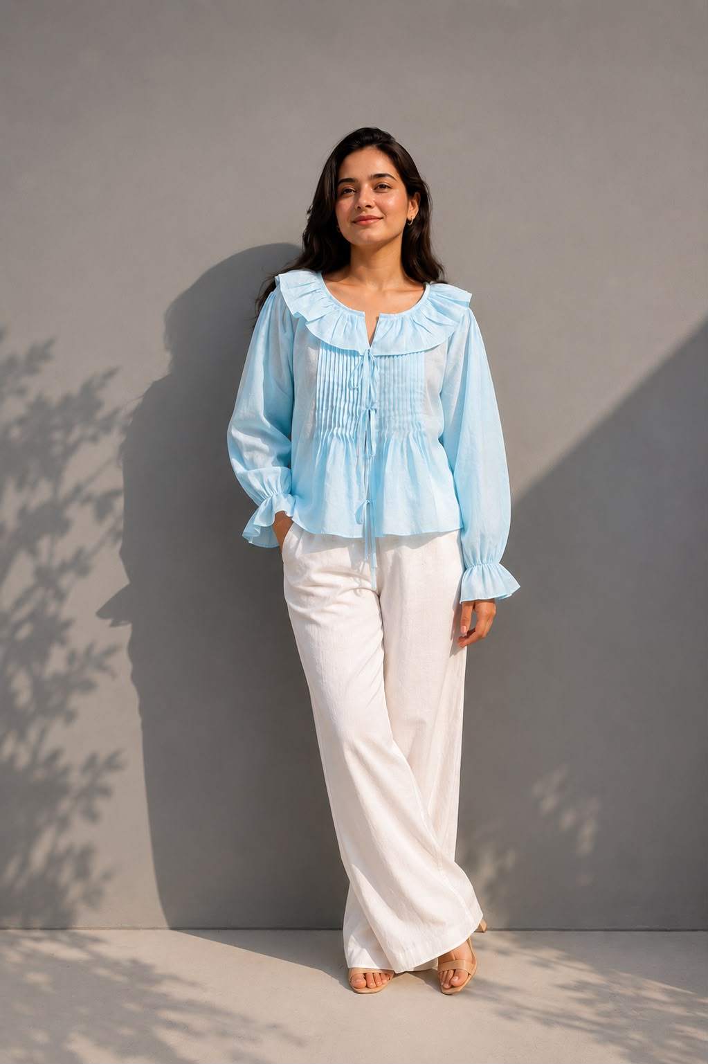 Women's sky blue cotton blouse featuring pintuck detailing and full sleeves.