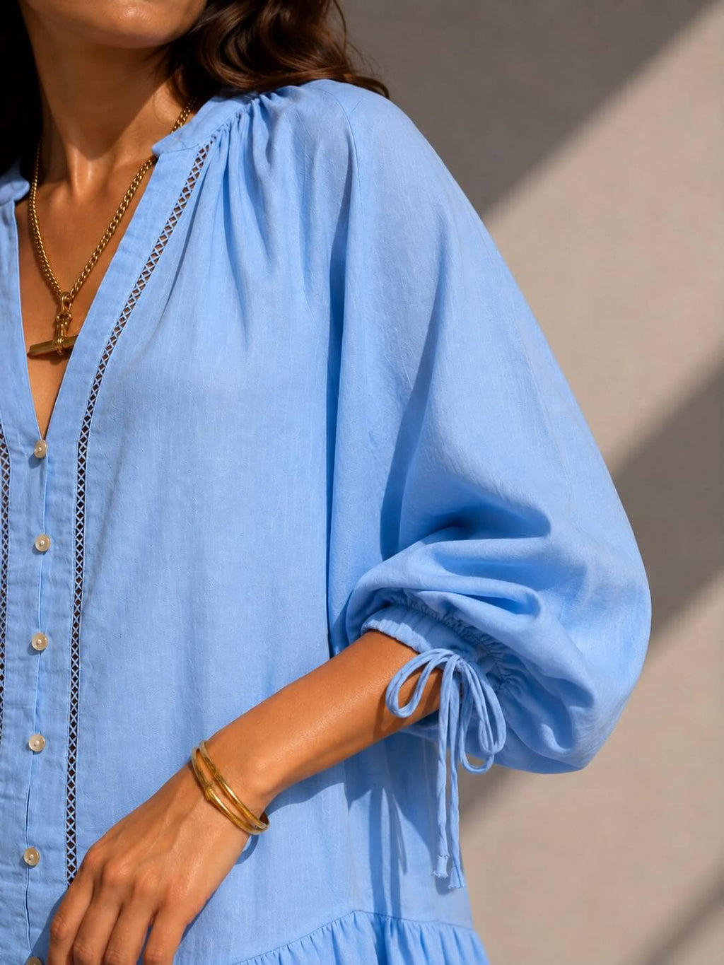 Relaxed fit sky blue vacation dress with lace trim and voluminous sleeves for women.
