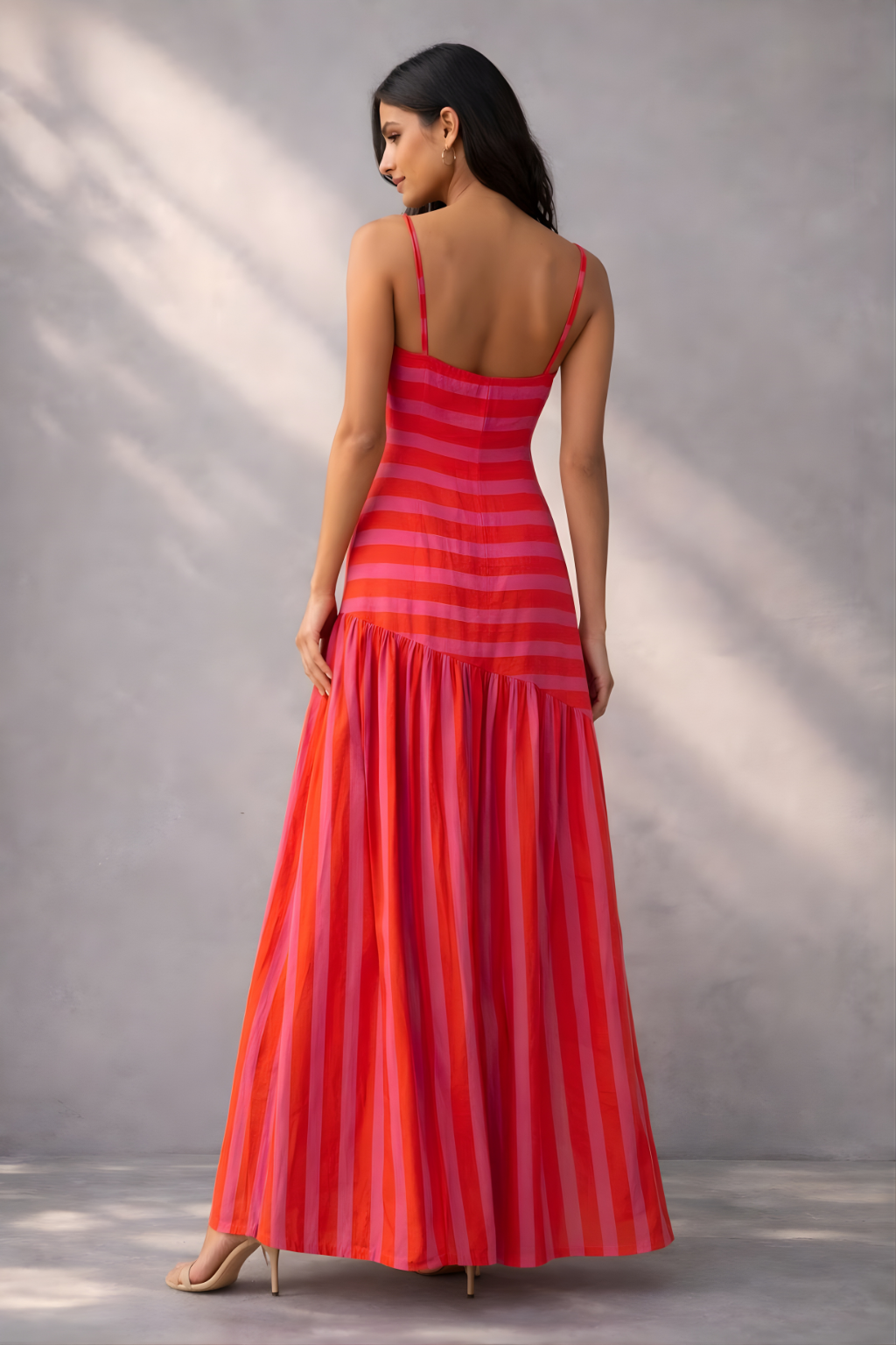 Sleeveless striped maxi dress in pink and orange with a relaxed summer silhouette
