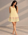 Yellow embroidered A-line dress with floral hem detailing