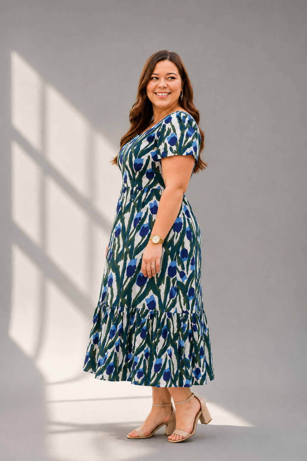 Side pose of floral tulip block print cotton midi dress with flutter sleeves